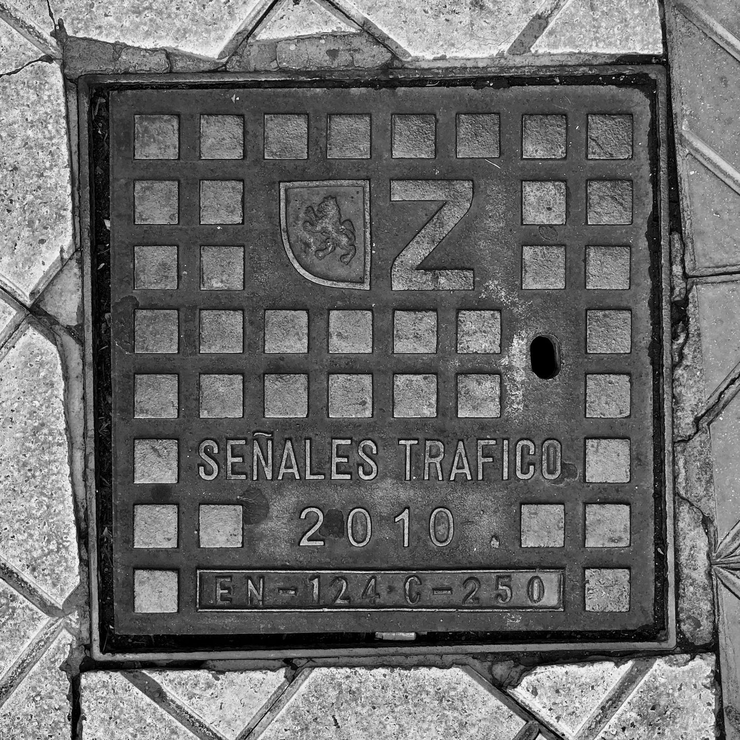 black and white image of a utility cover