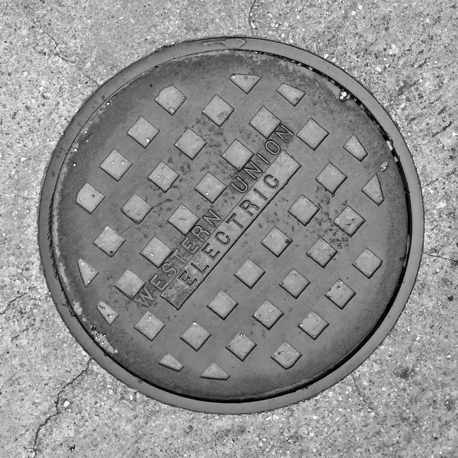 black and white image of a utility cover