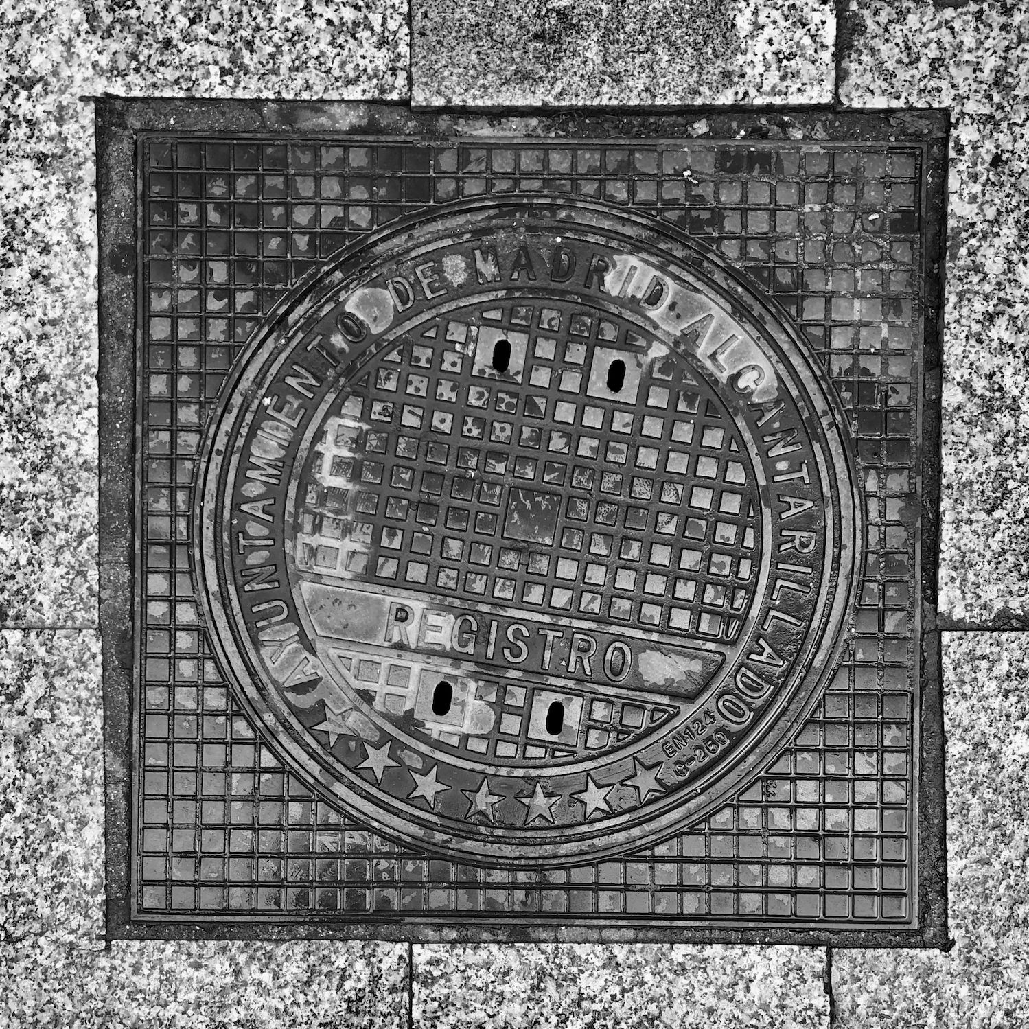 black and white image of a utility cover