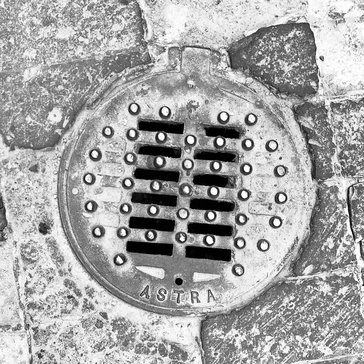 black and white image of a utility cover
