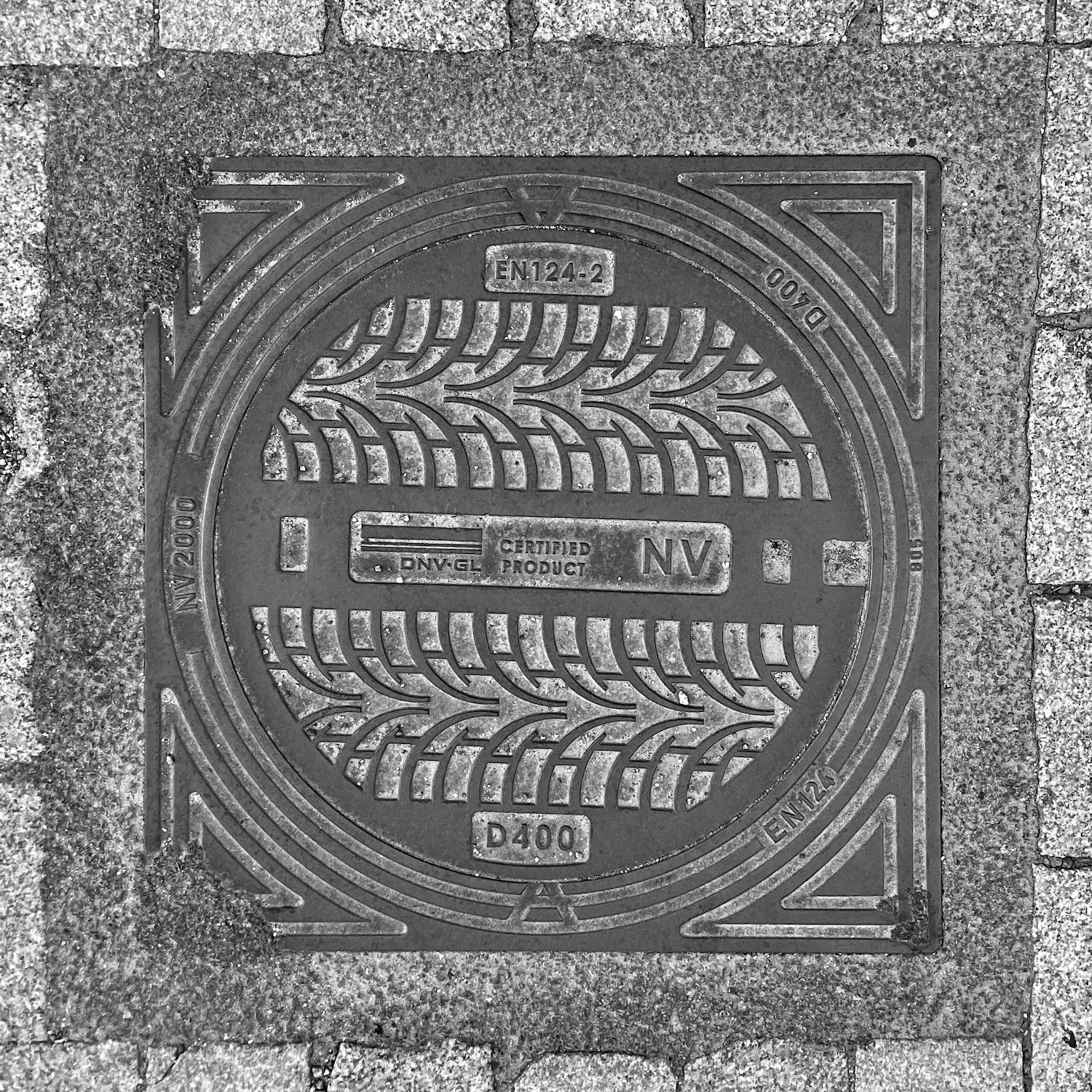 black and white image of a utility cover