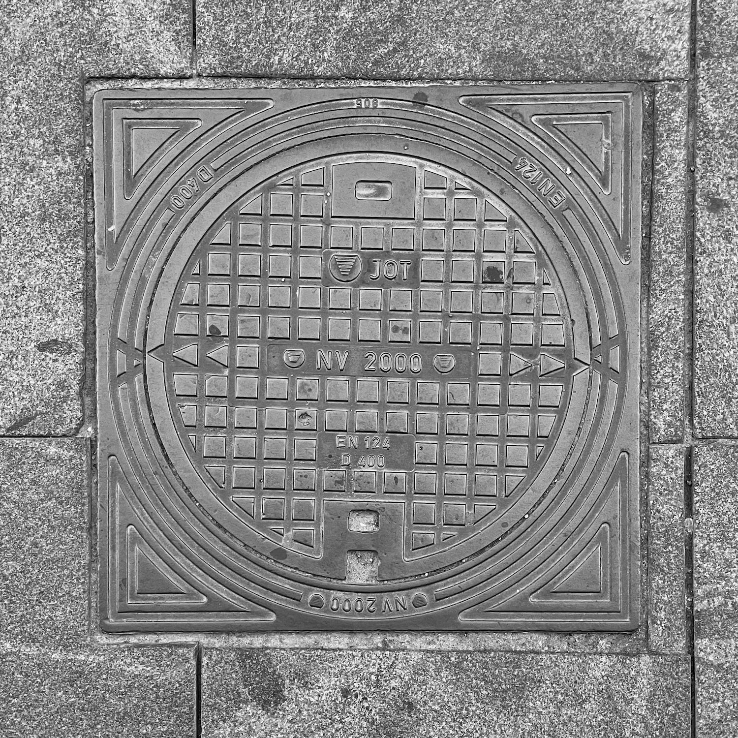 black and white image of a utility cover