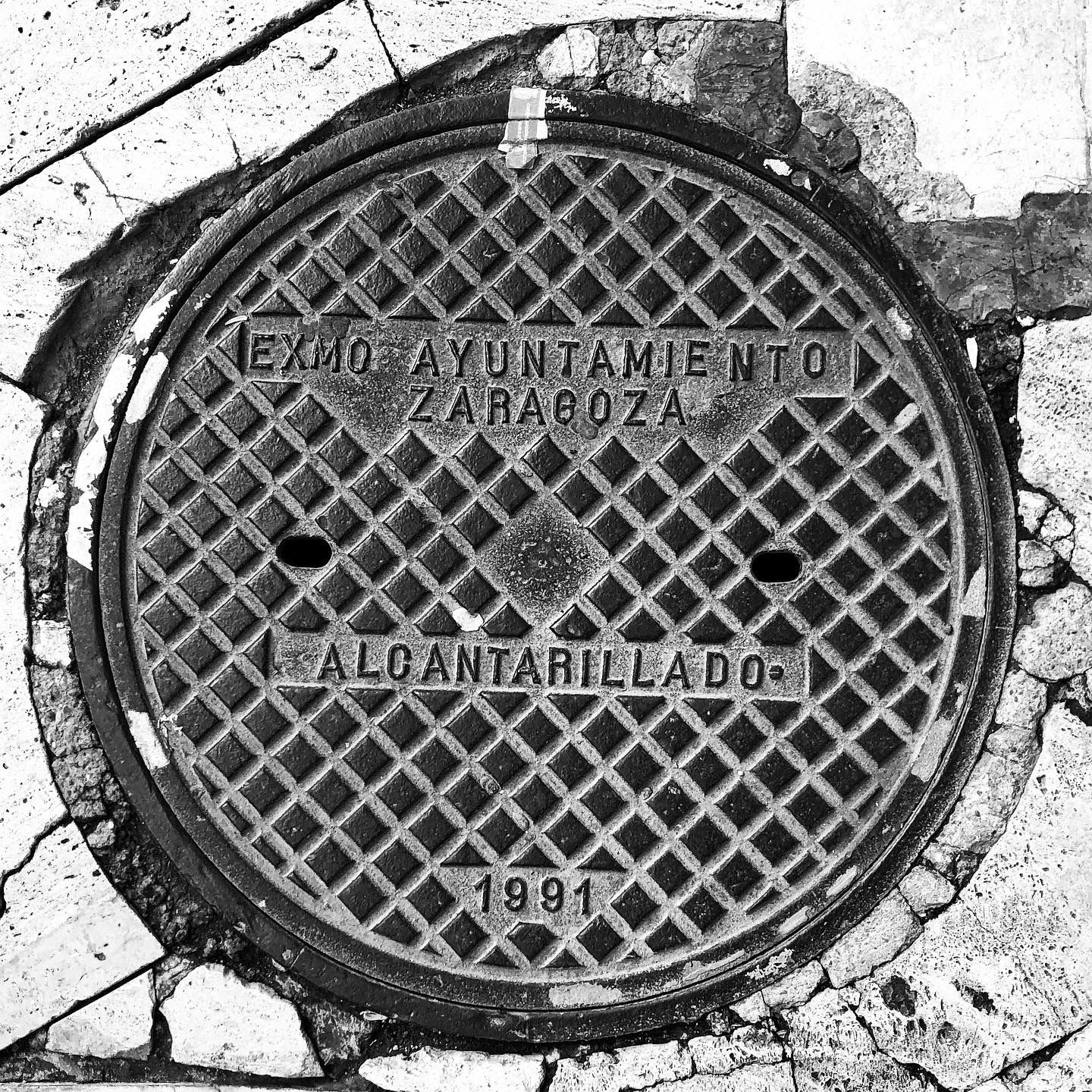 black and white image of a utility cover