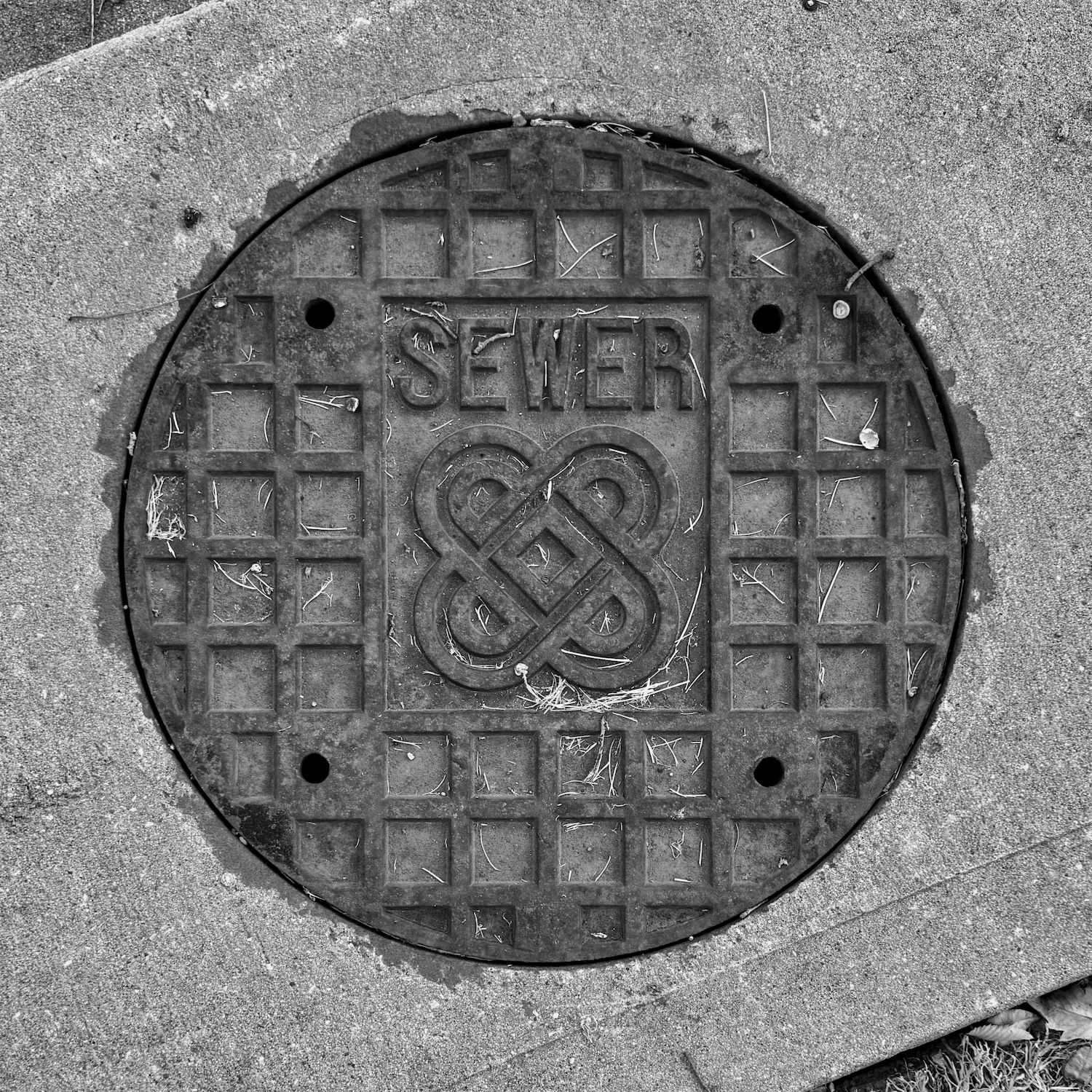 black and white image of a utility cover