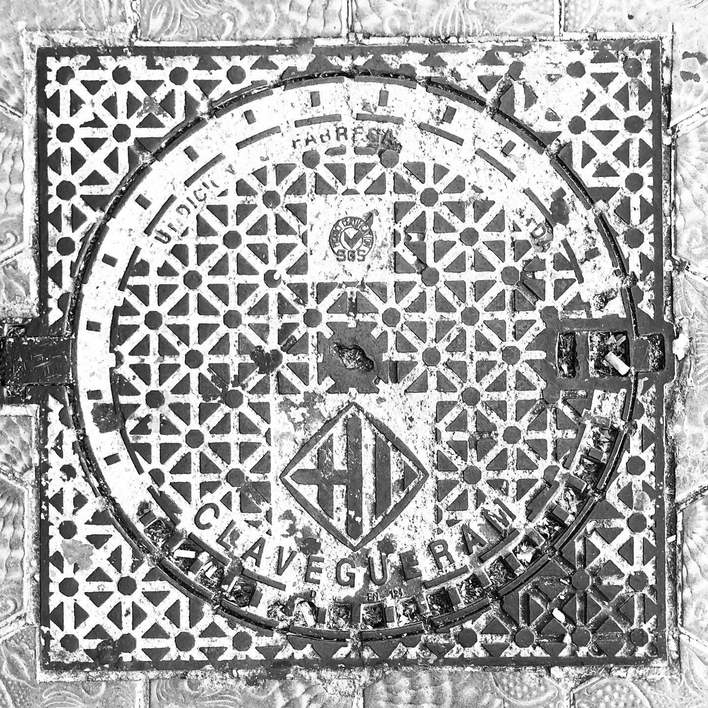 black and white image of a utility cover