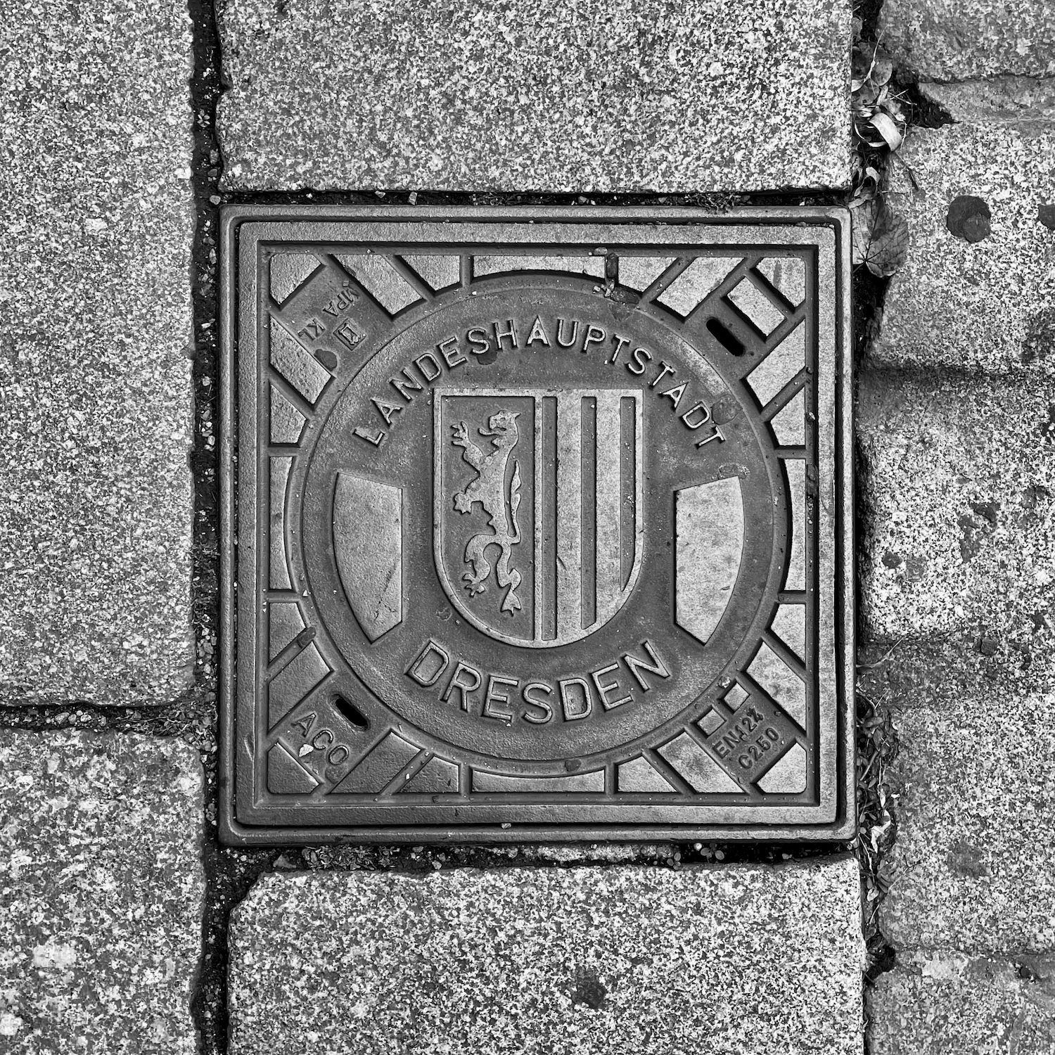 black and white image of a utility cover