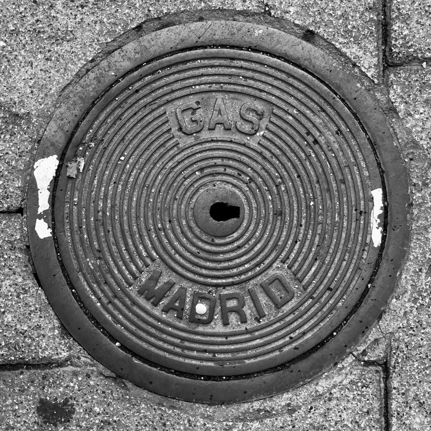 black and white image of a utility cover
