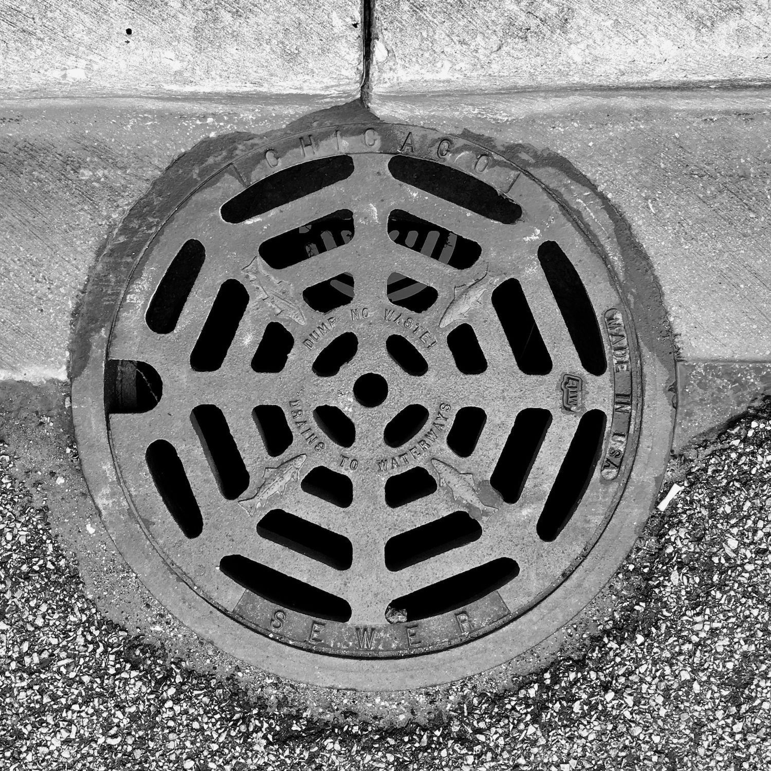 black and white image of a utility cover