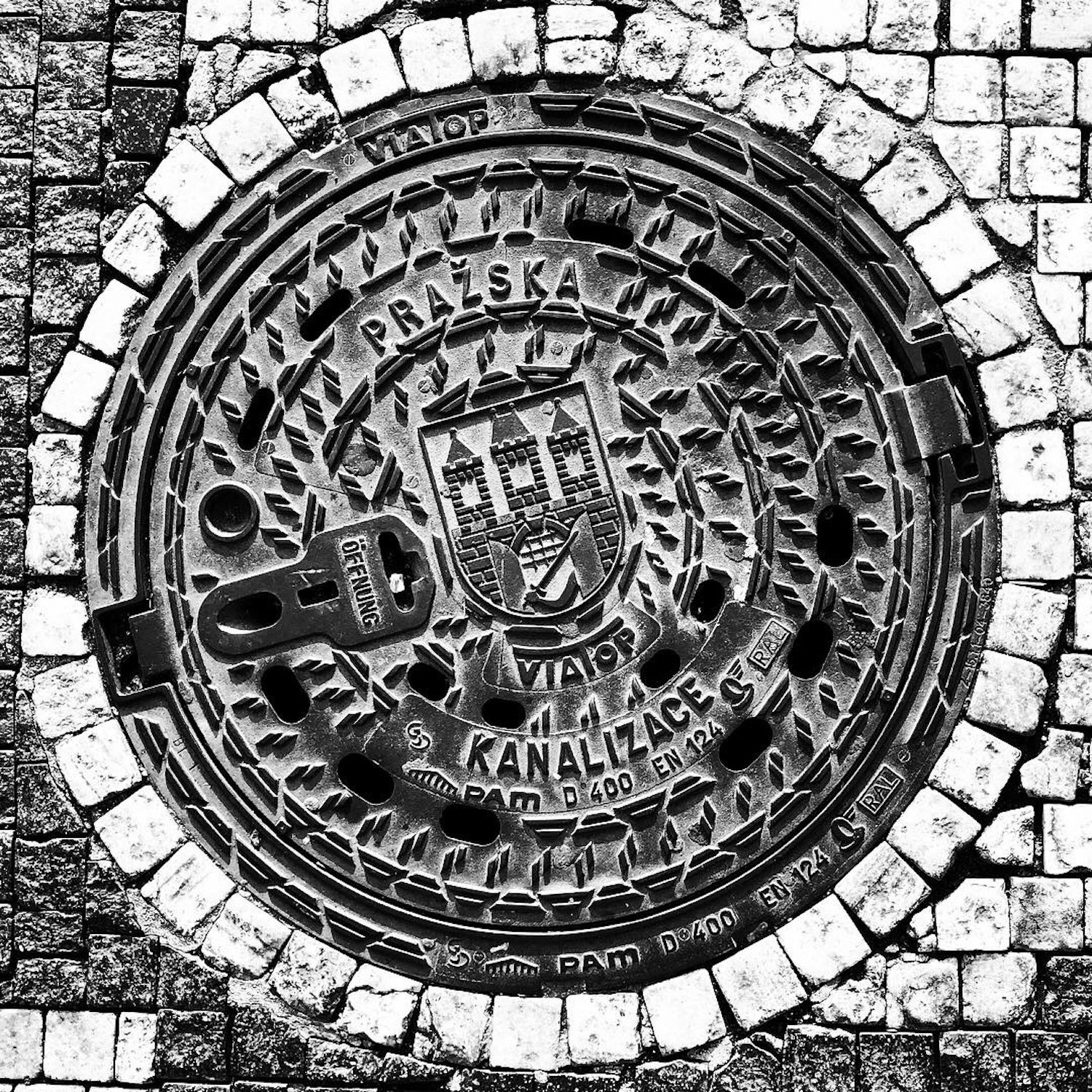 black and white image of a utility cover