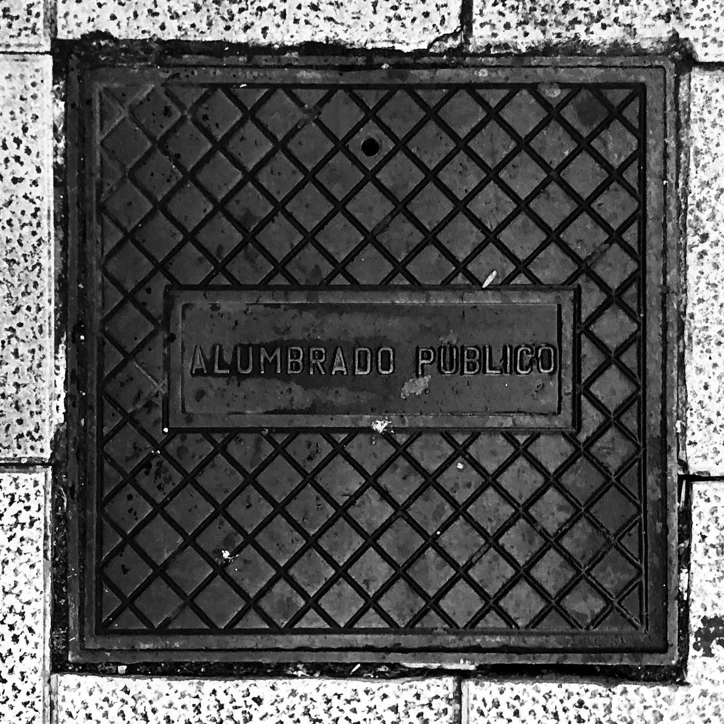 black and white image of a utility cover