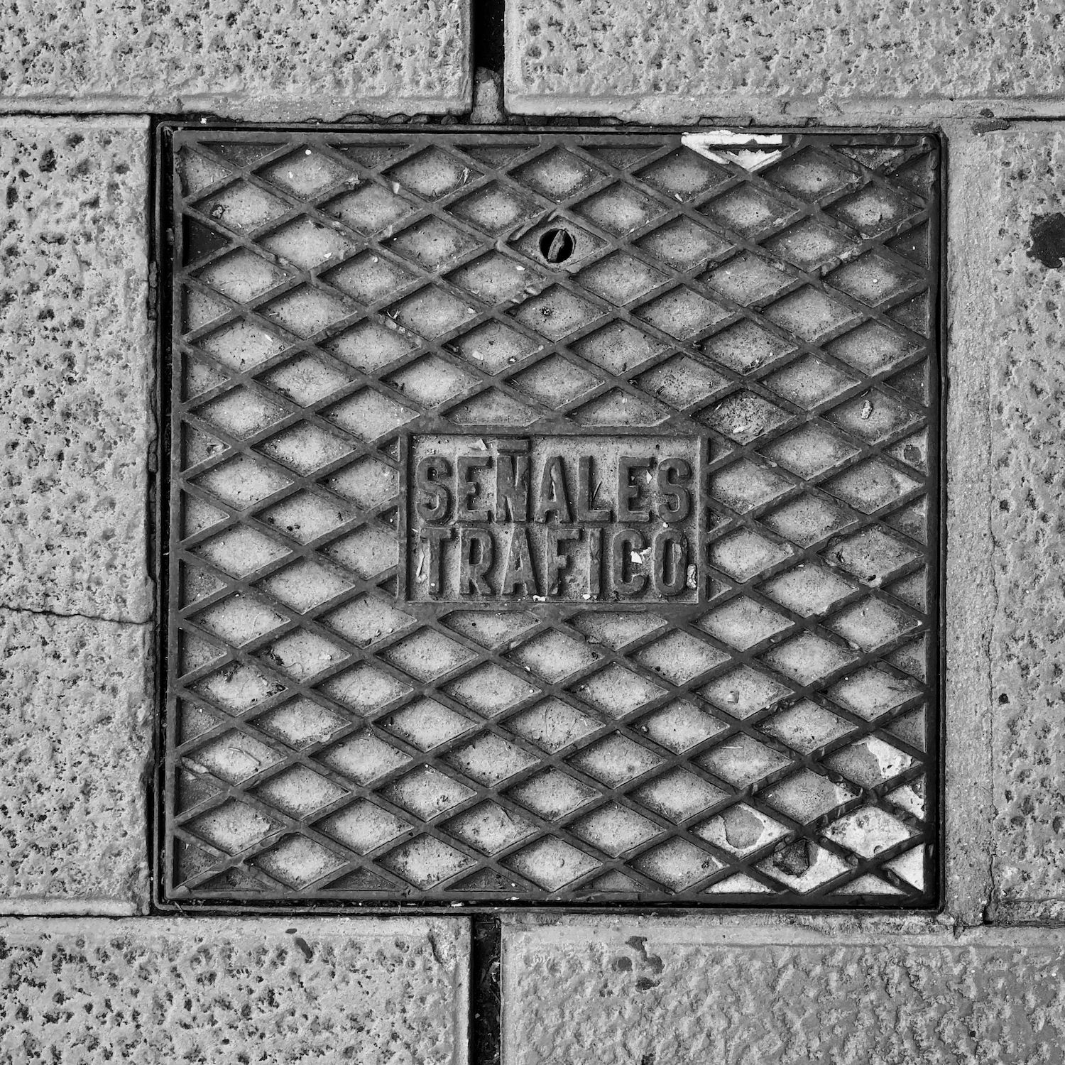 black and white image of a utility cover
