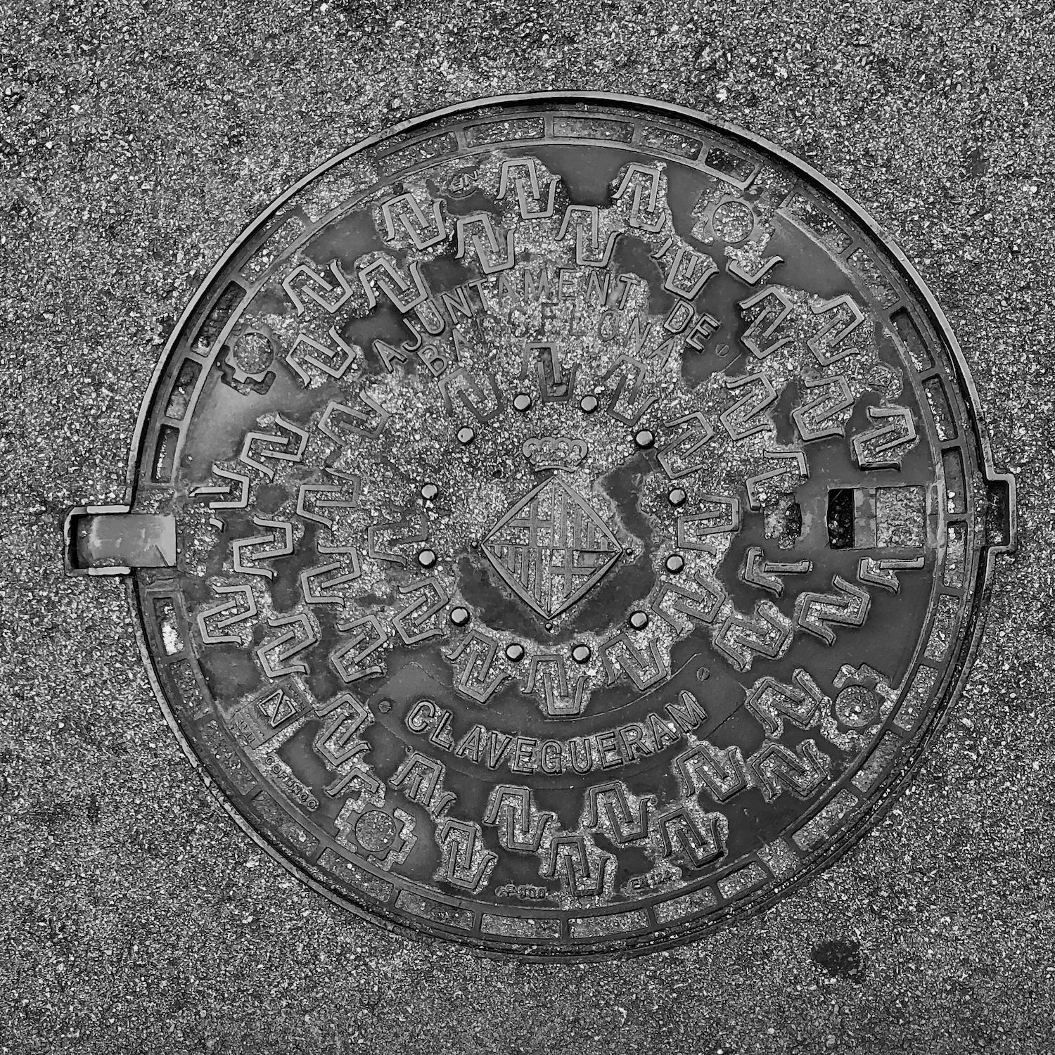black and white image of a utility cover