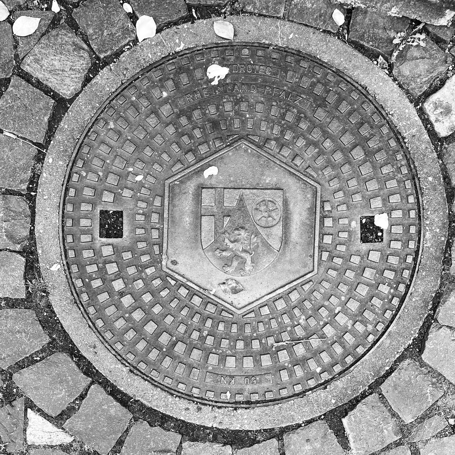 black and white image of a utility cover