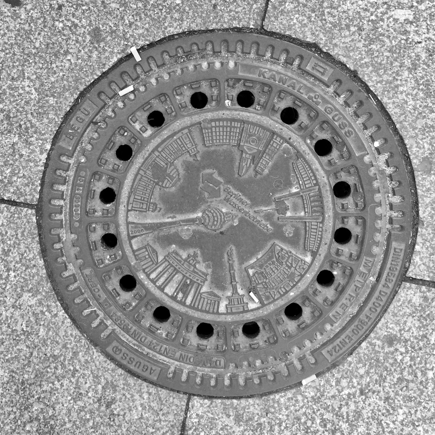 black and white image of a utility cover