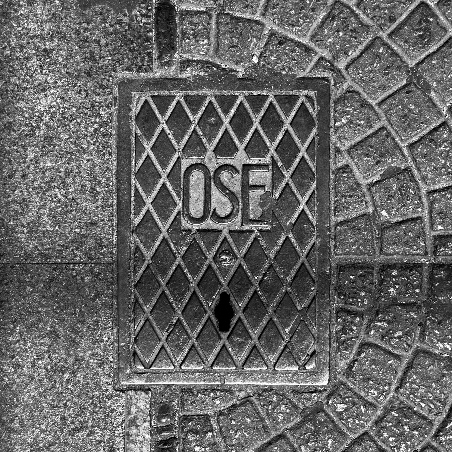 black and white image of a utility cover
