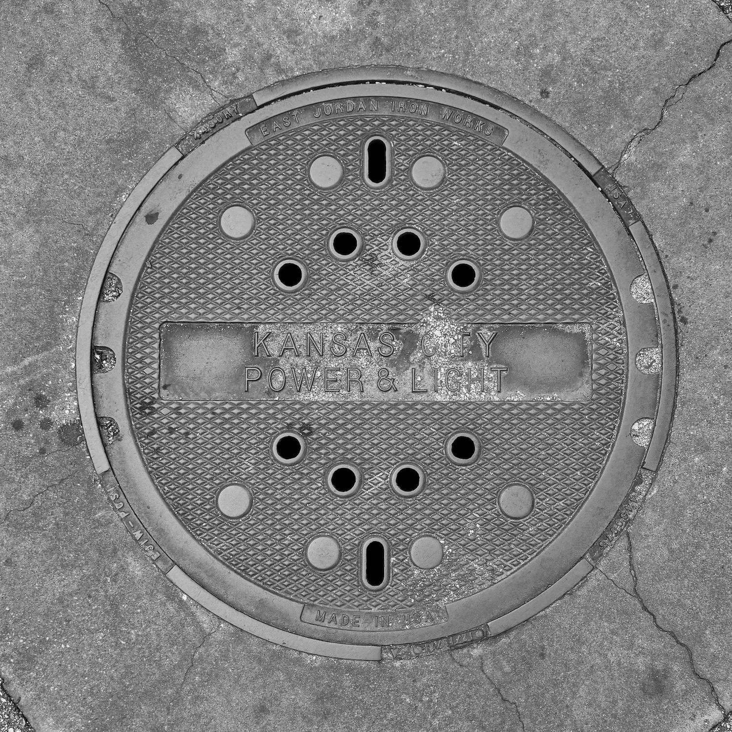 black and white image of a utility cover