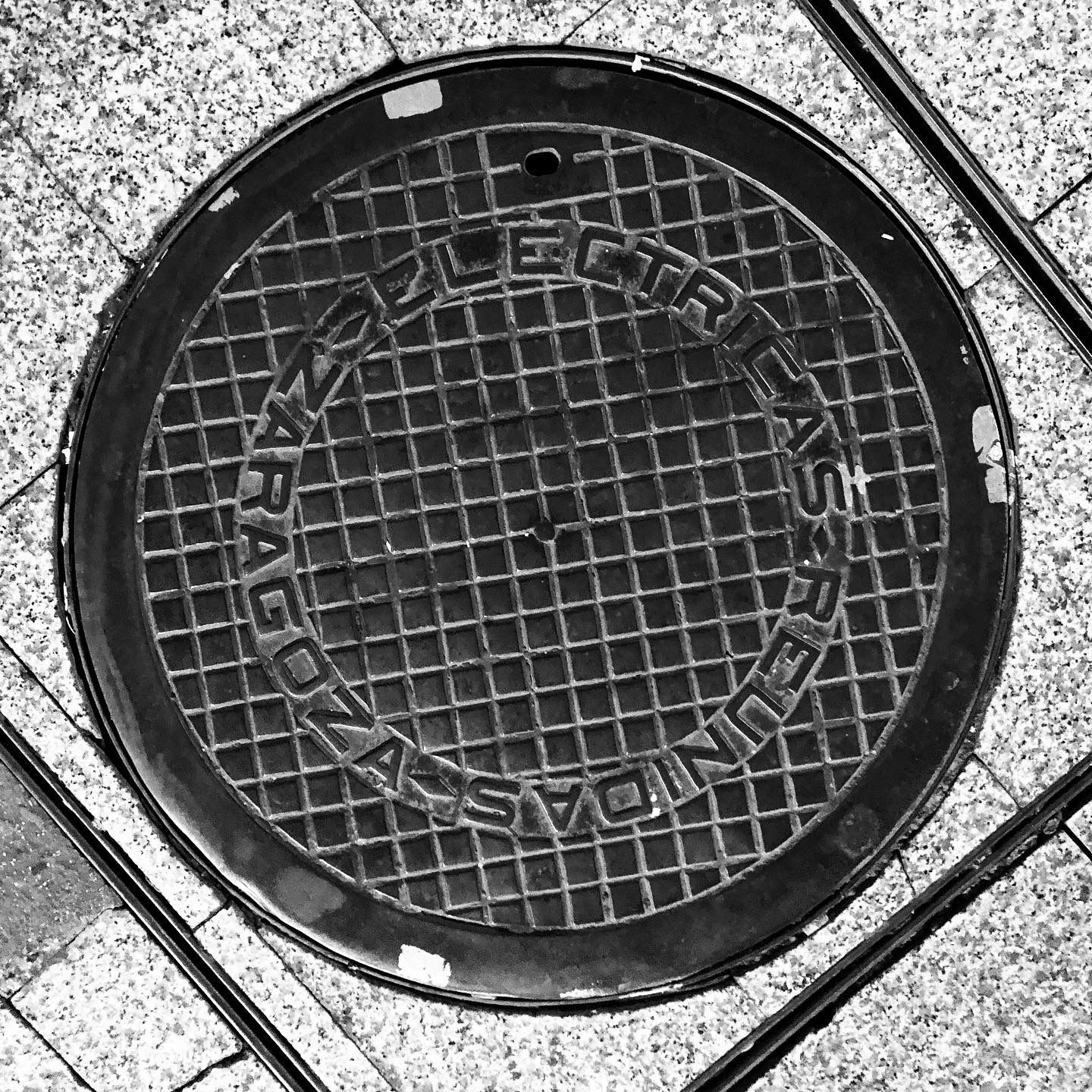 black and white image of a utility cover