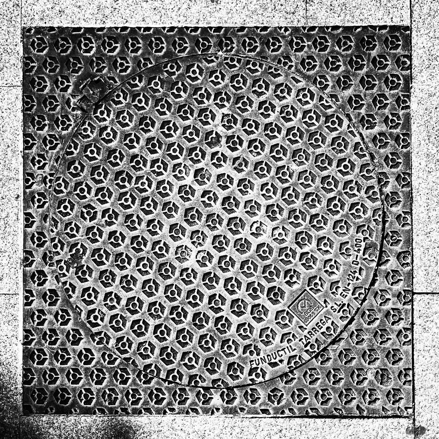 black and white image of a utility cover