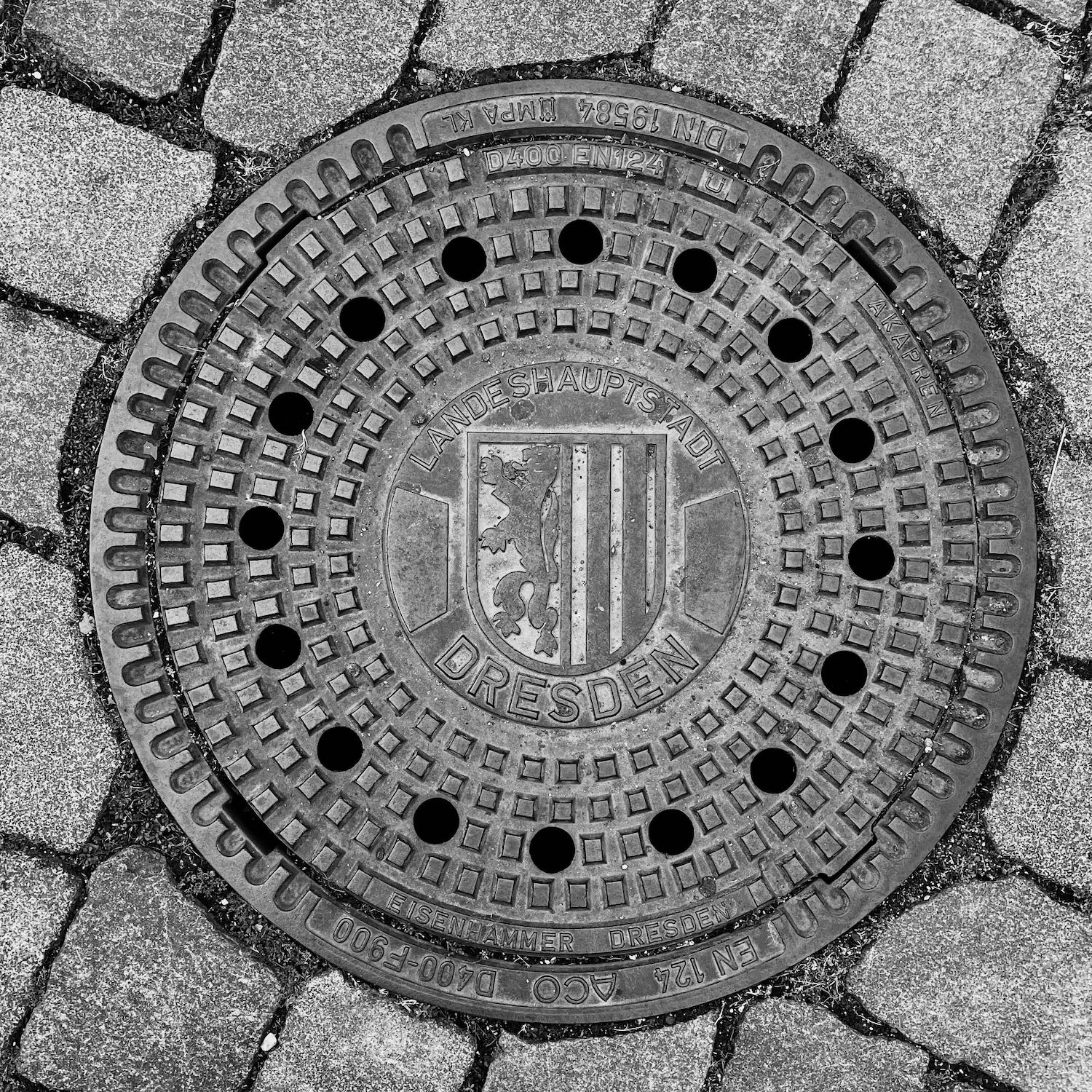 black and white image of a utility cover