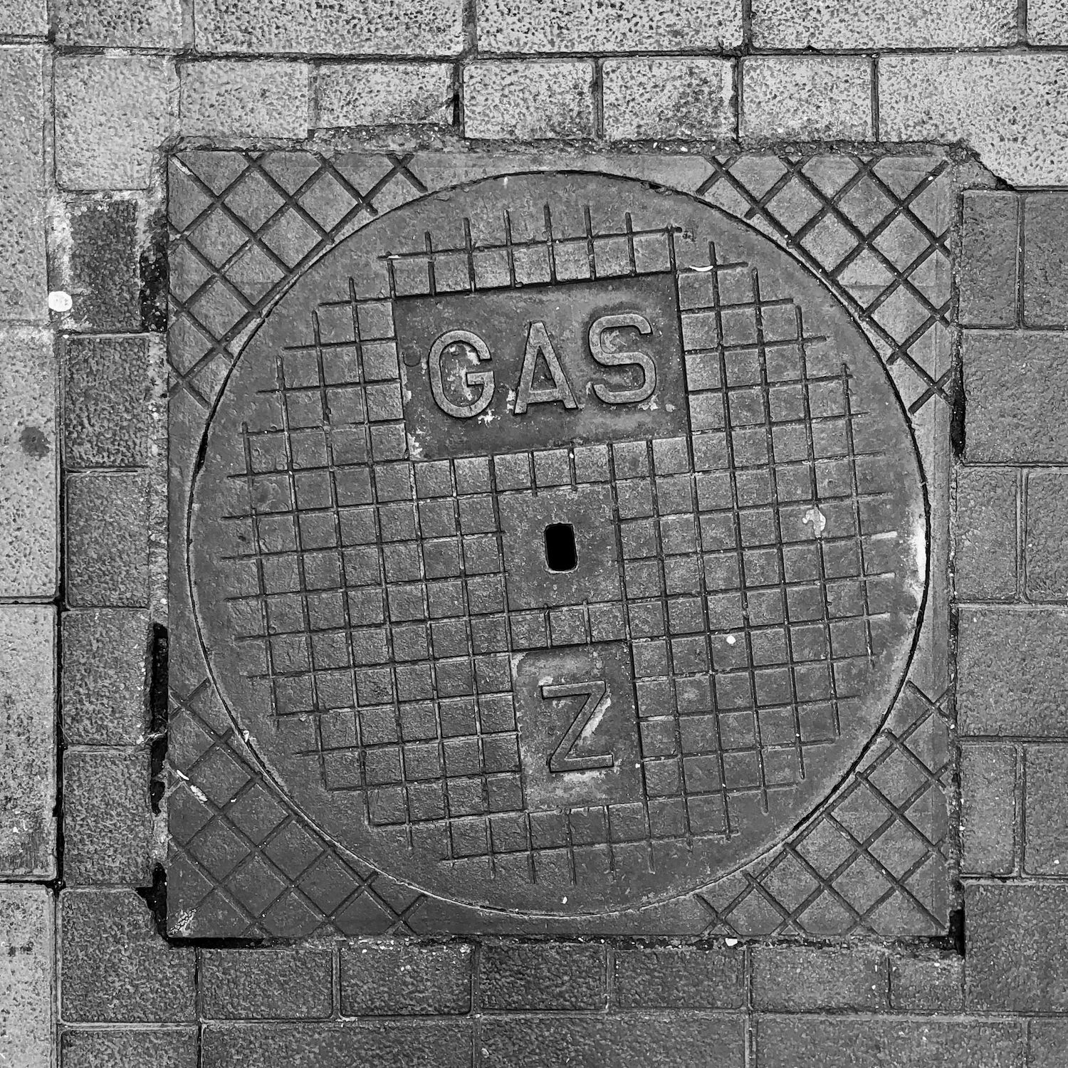 black and white image of a utility cover