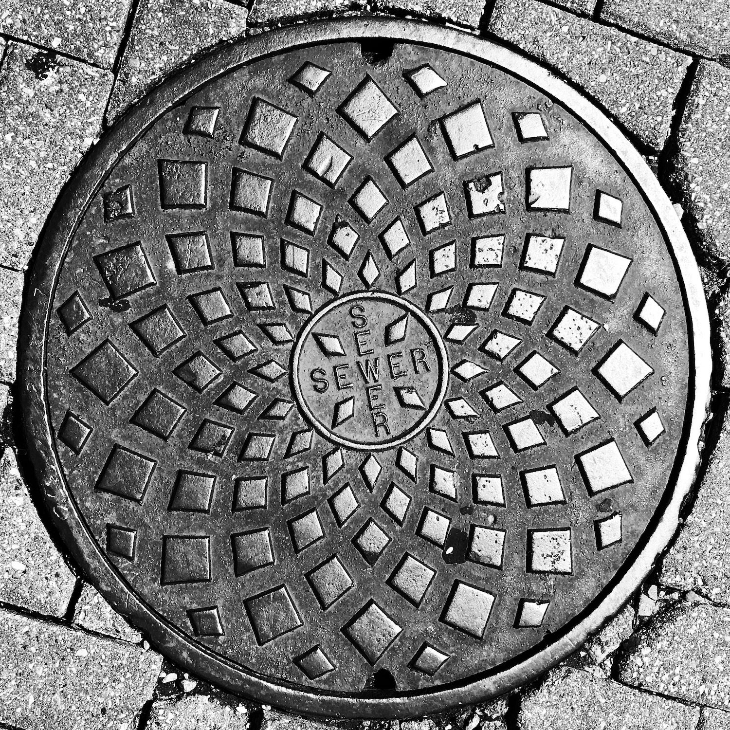 black and white image of a utility cover