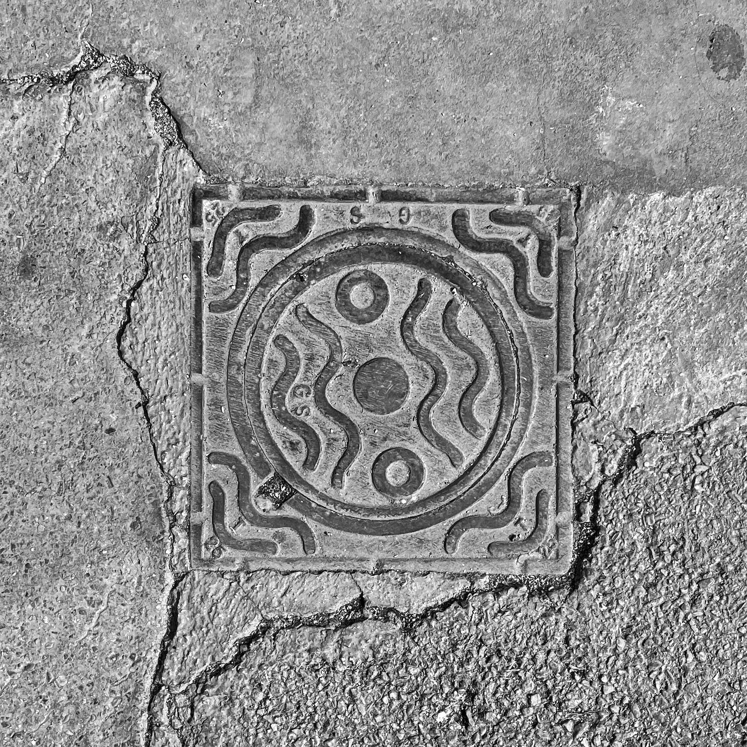 black and white image of a utility cover
