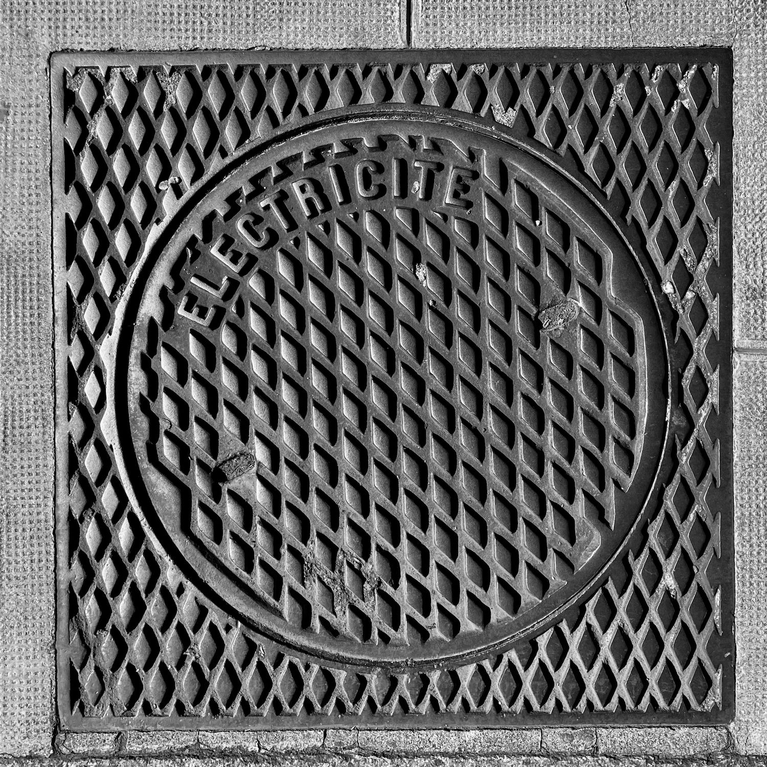 black and white image of a utility cover