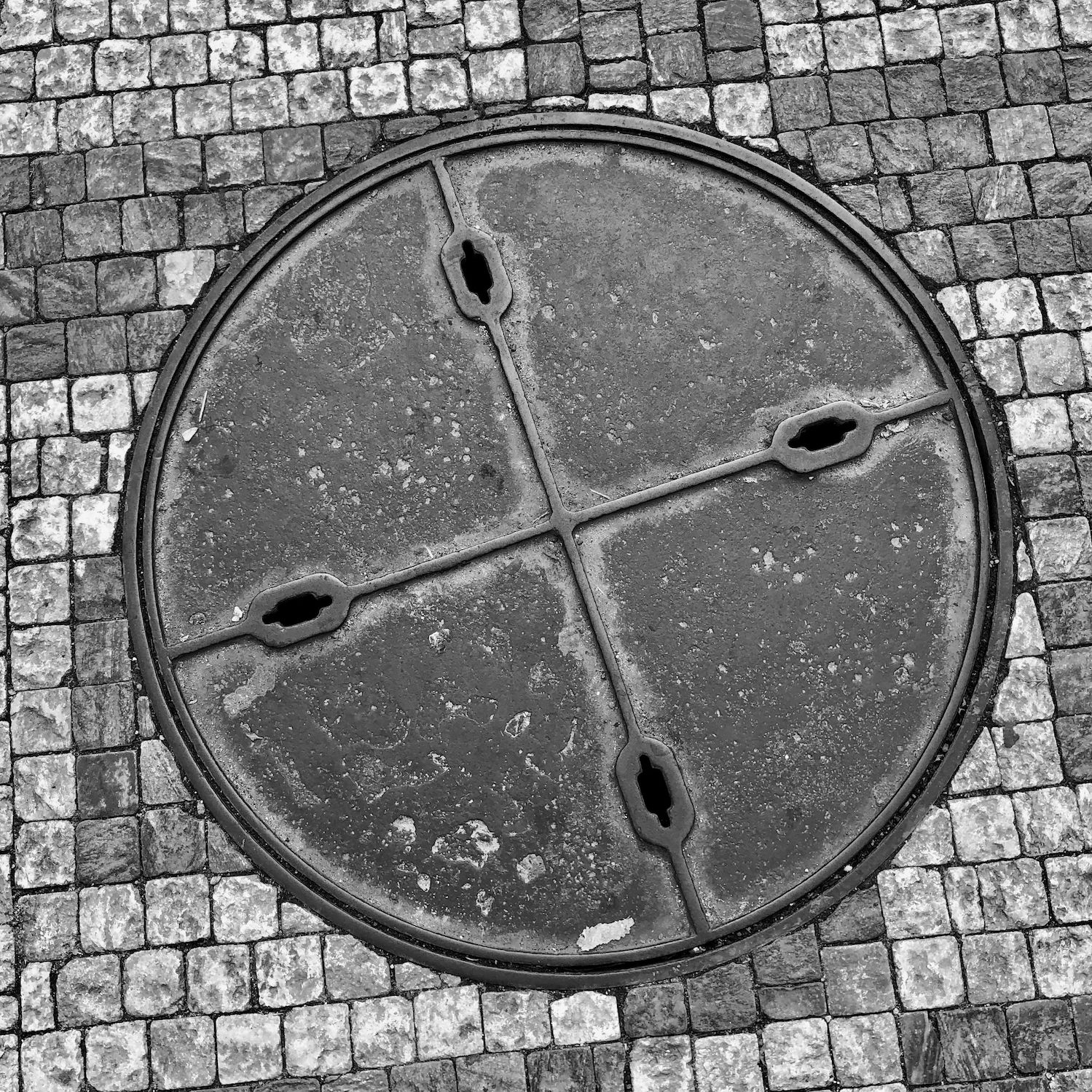 black and white image of a utility cover