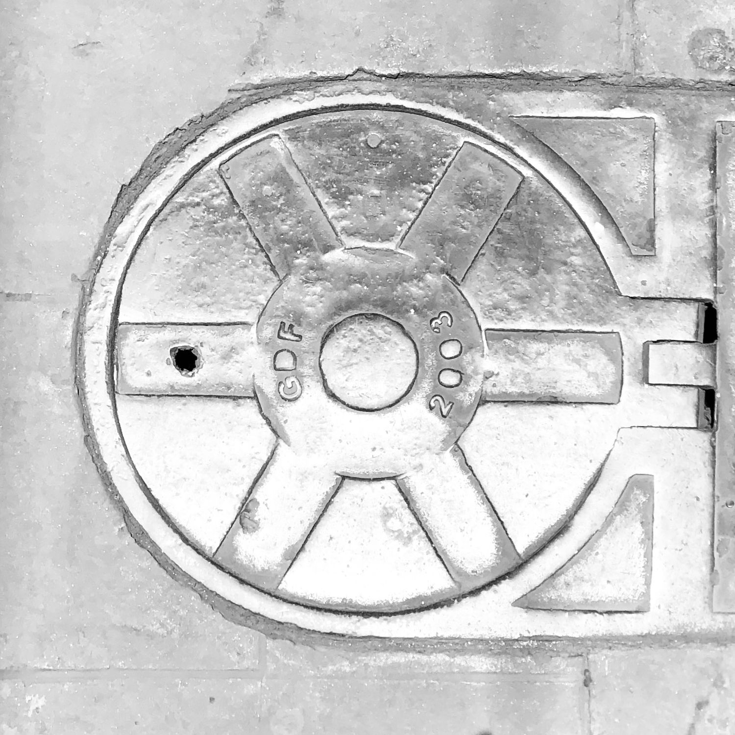black and white image of a utility cover
