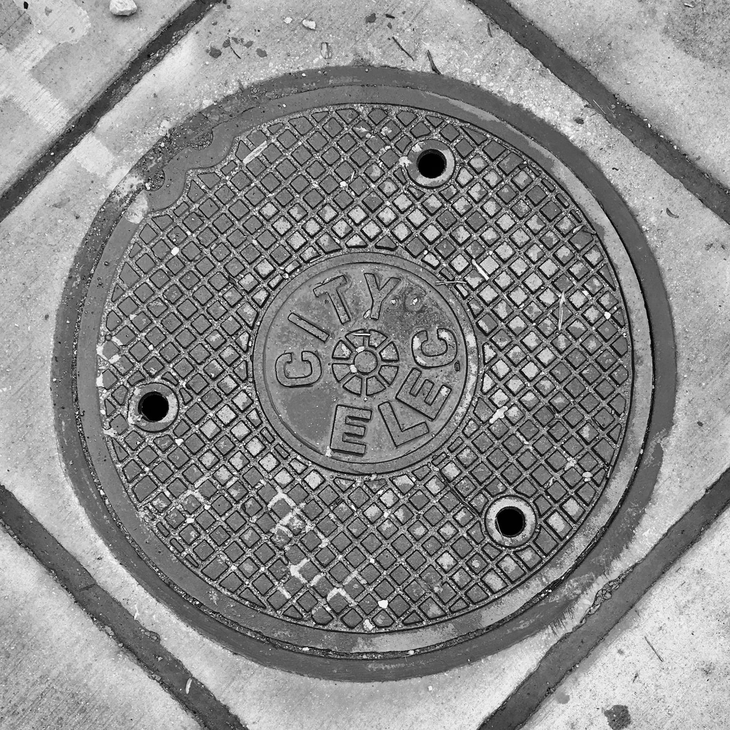 black and white image of a utility cover