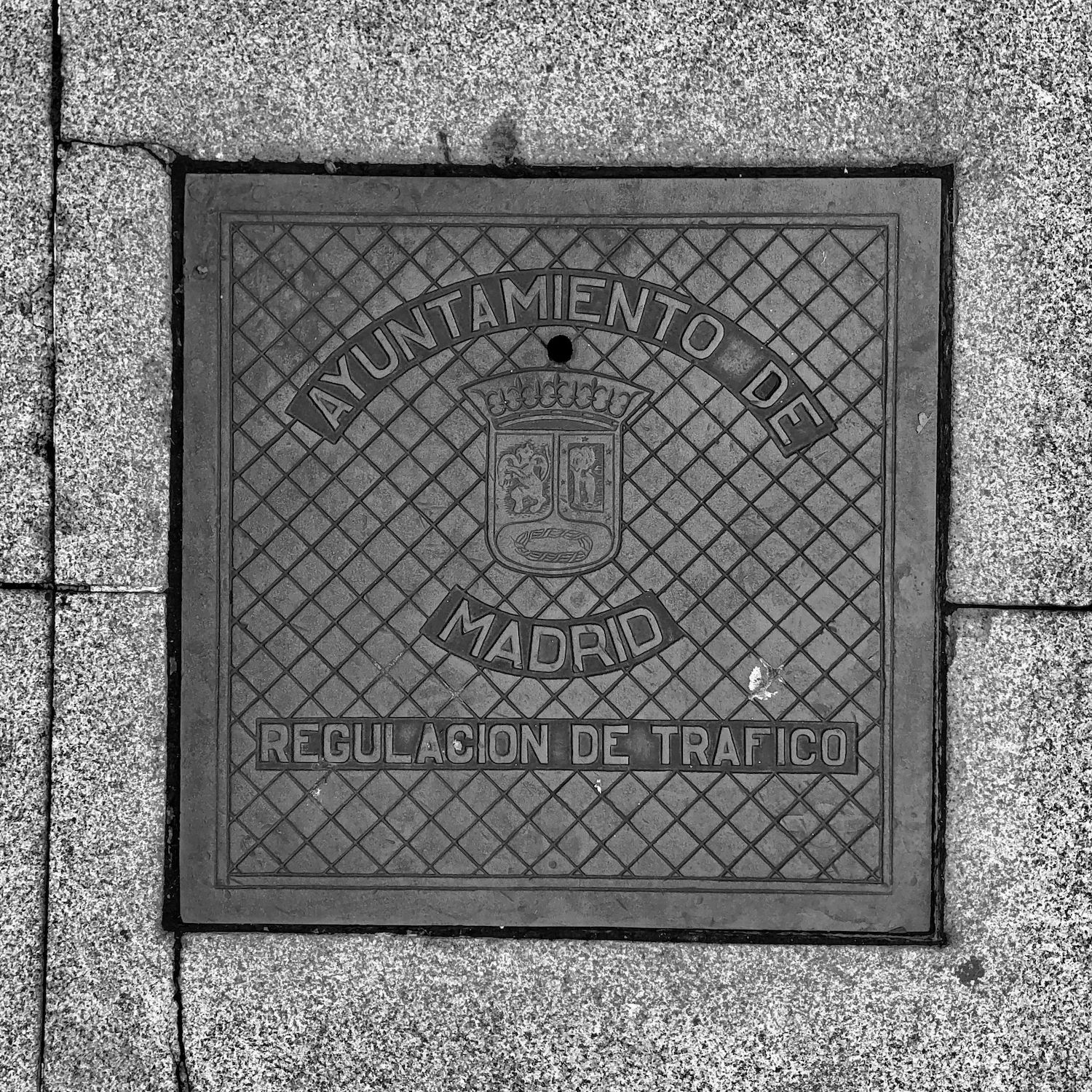 black and white image of a utility cover