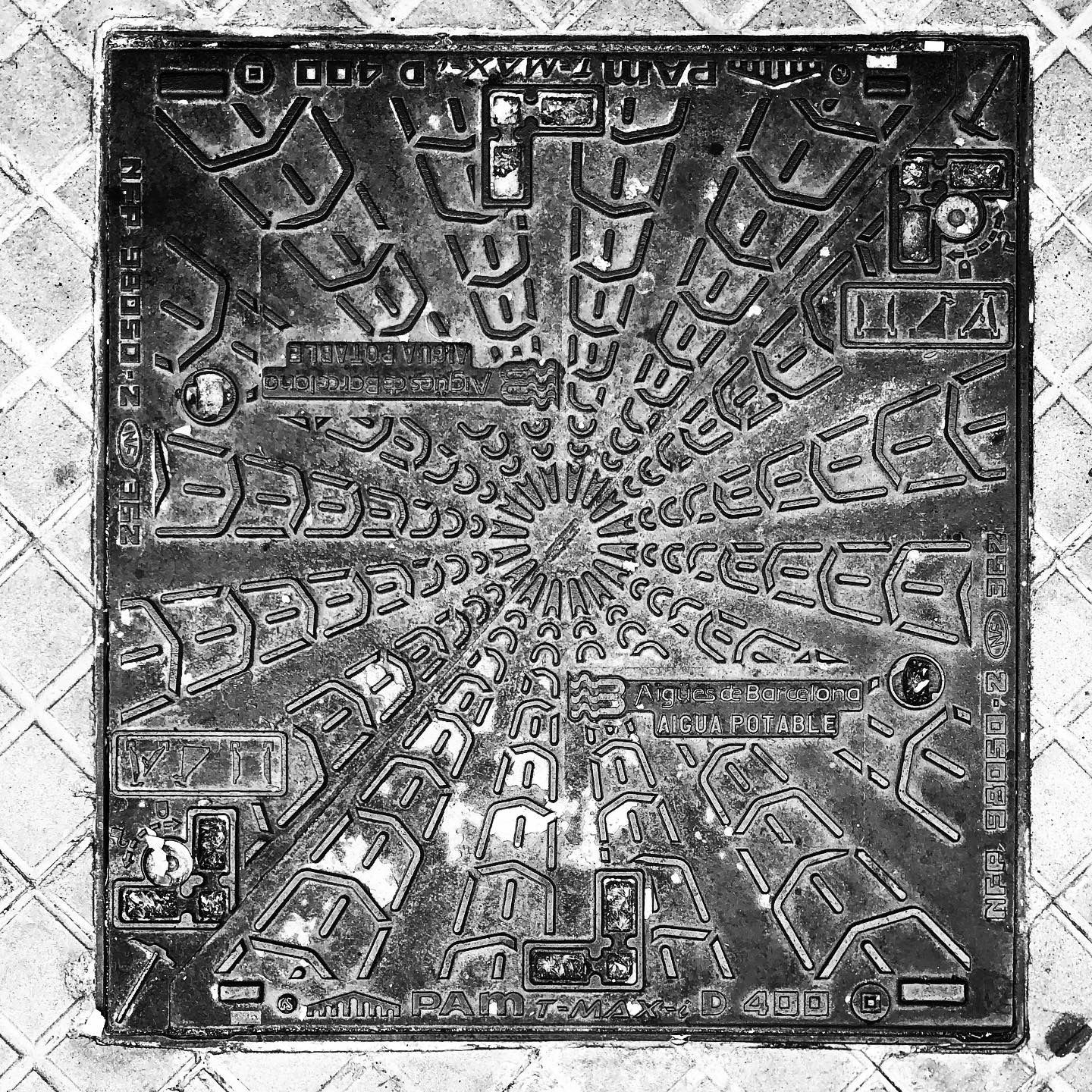 black and white image of a utility cover