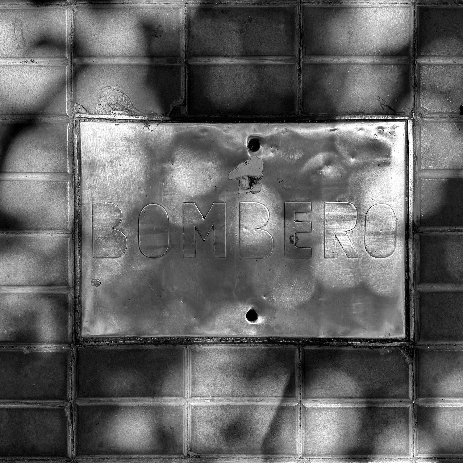 black and white image of a utility cover