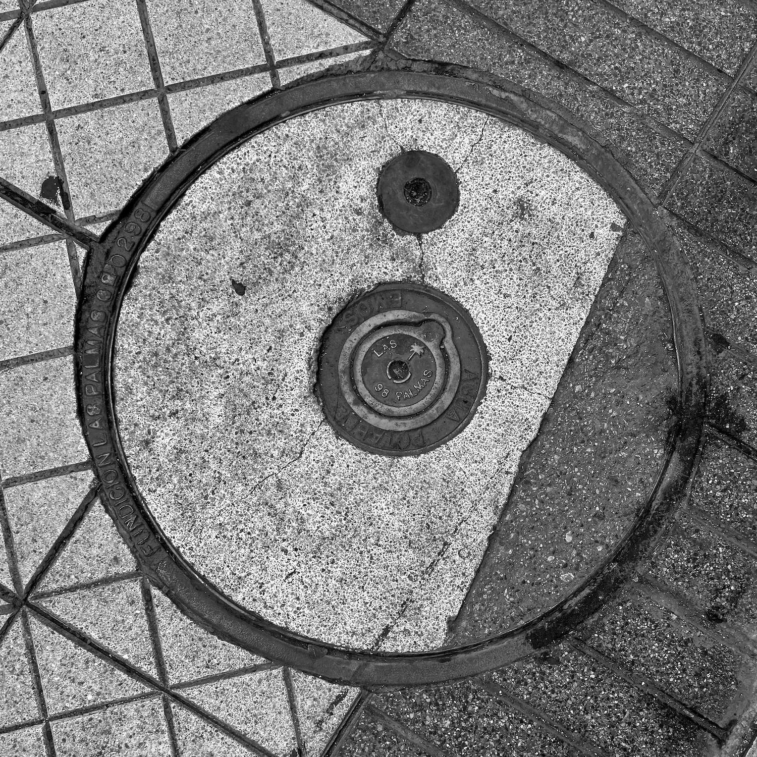 black and white image of a utility cover