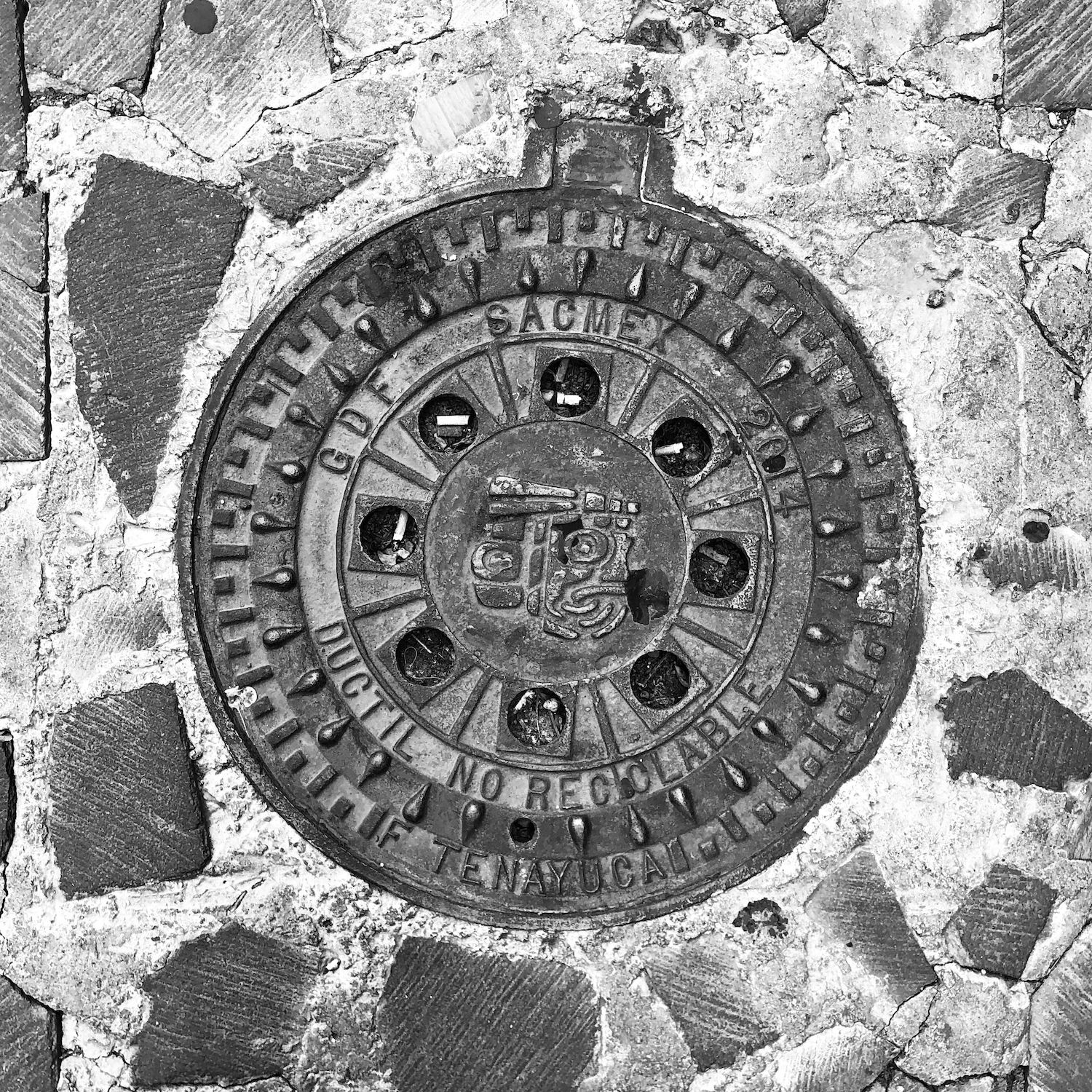 black and white image of a utility cover