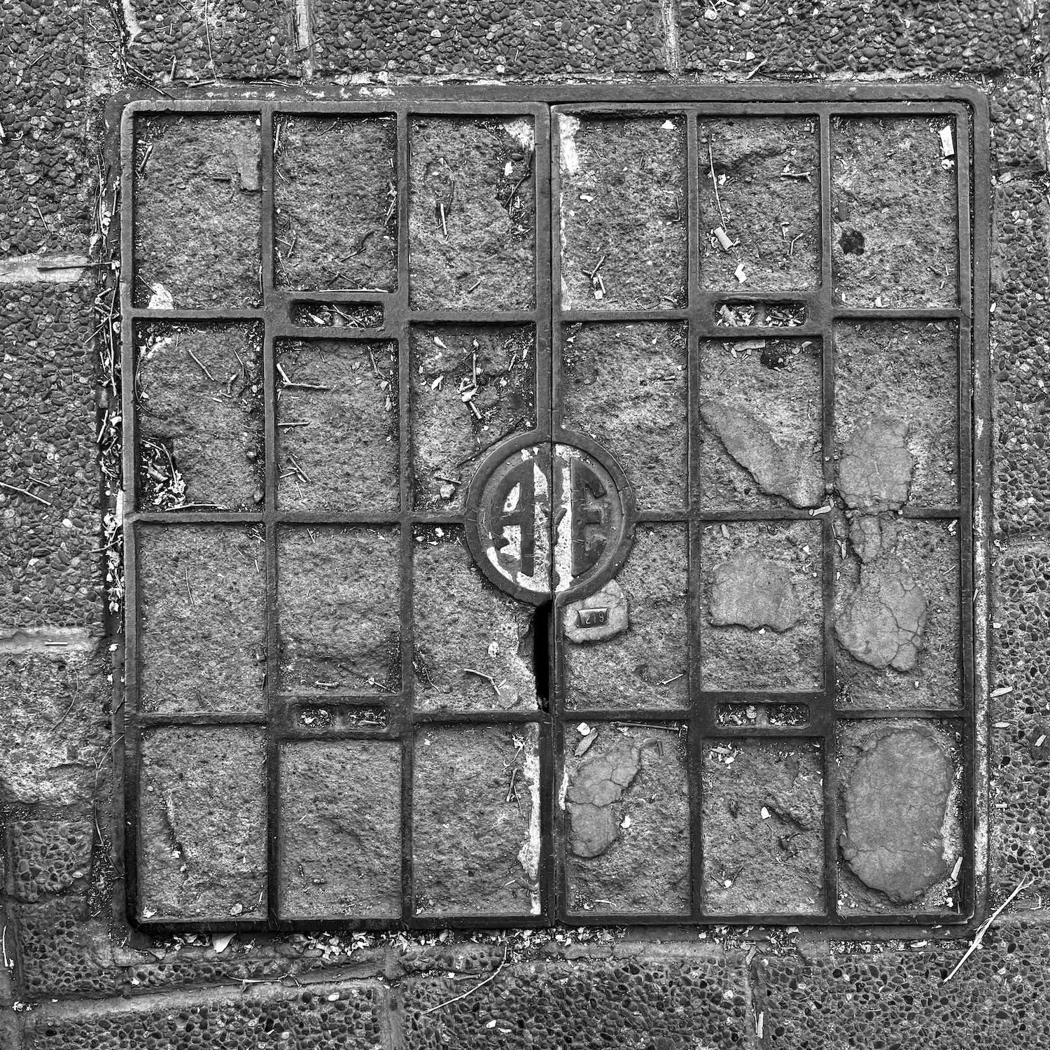 black and white image of a utility cover