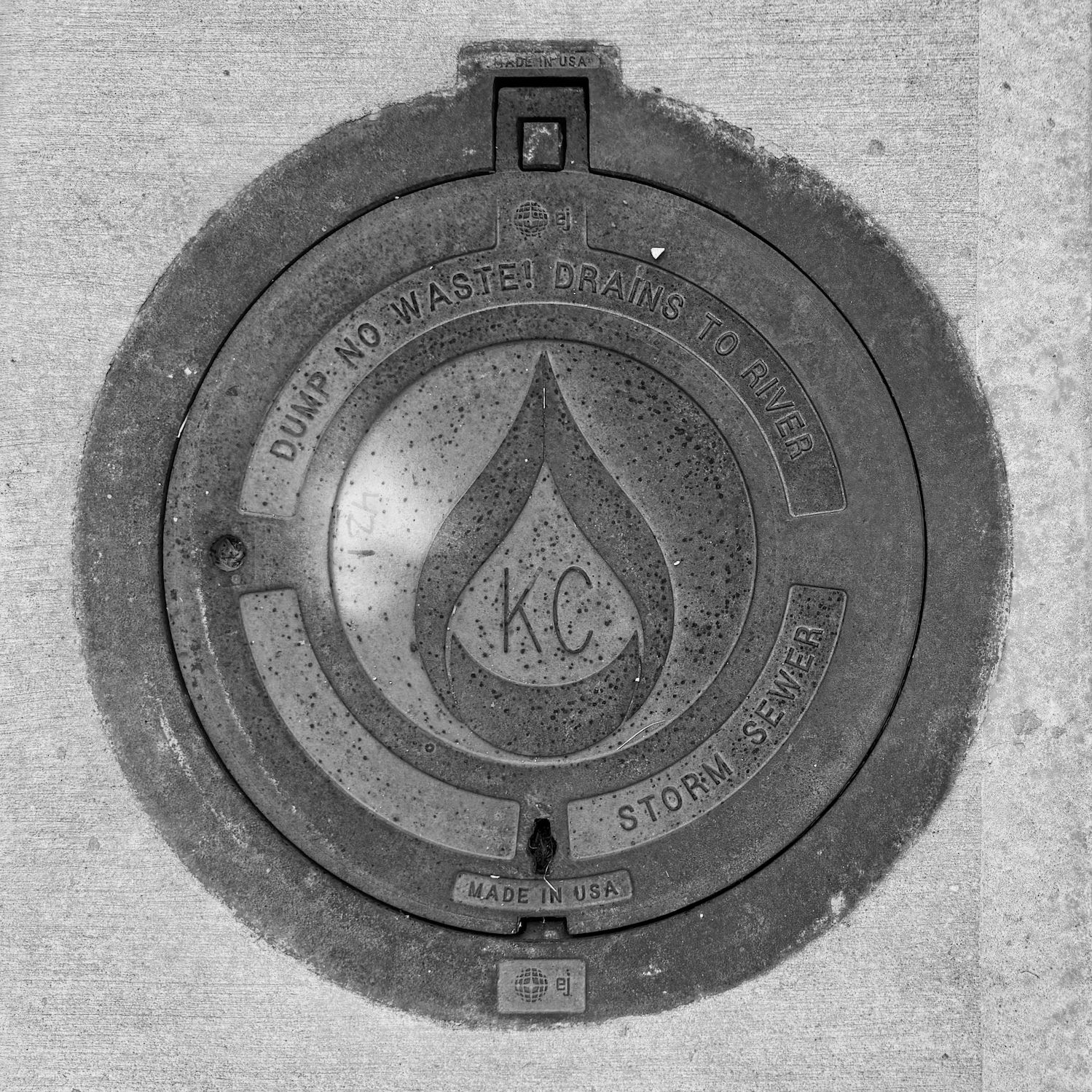 black and white image of a utility cover
