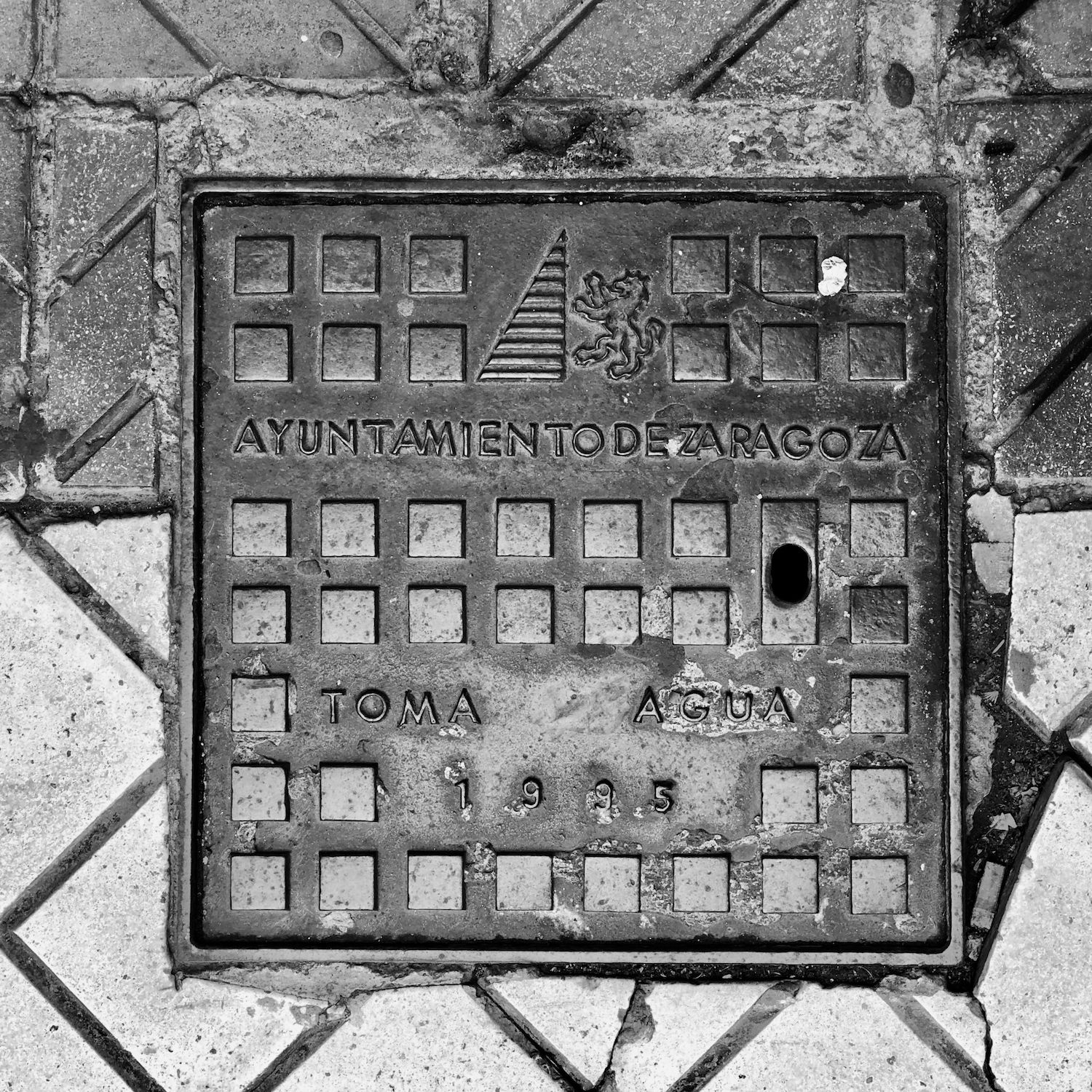 black and white image of a utility cover