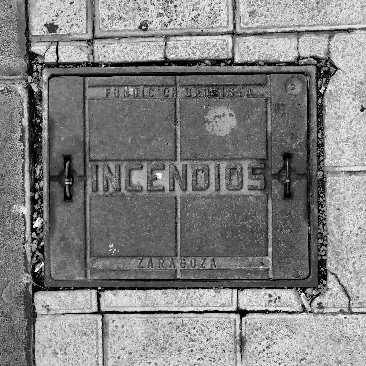 black and white image of a utility cover