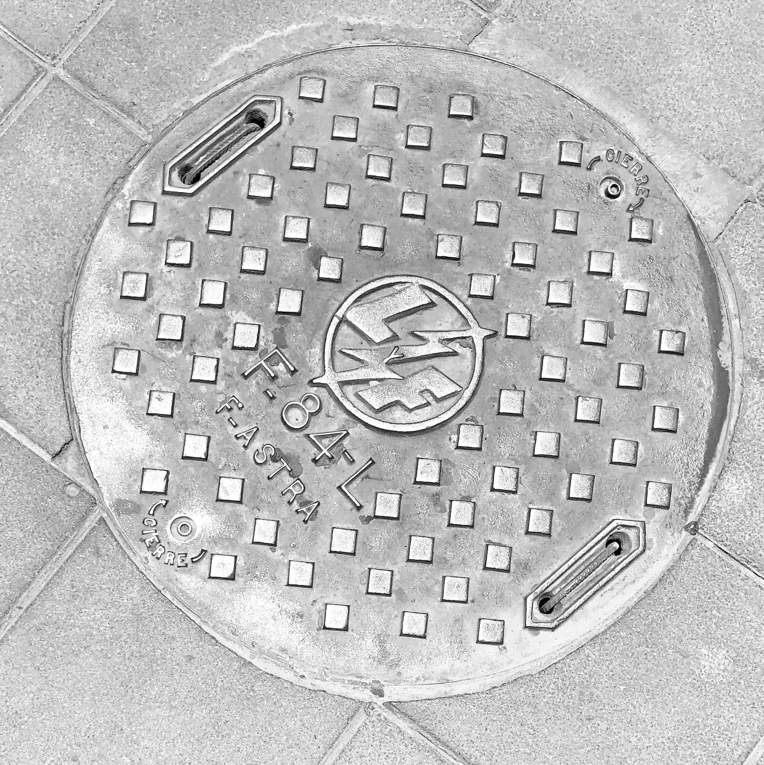 black and white image of a utility cover
