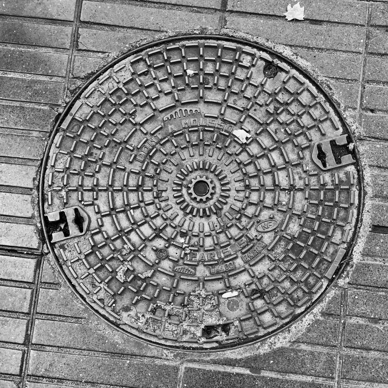 black and white image of a utility cover