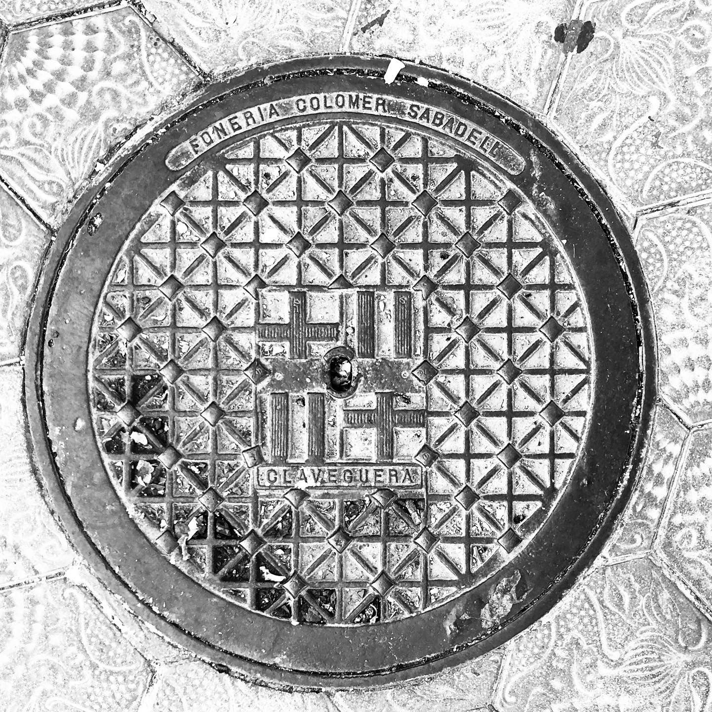 black and white photo of a utility cover