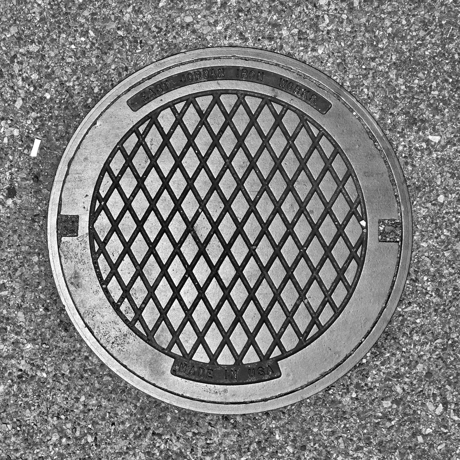 black and white image of a utility cover