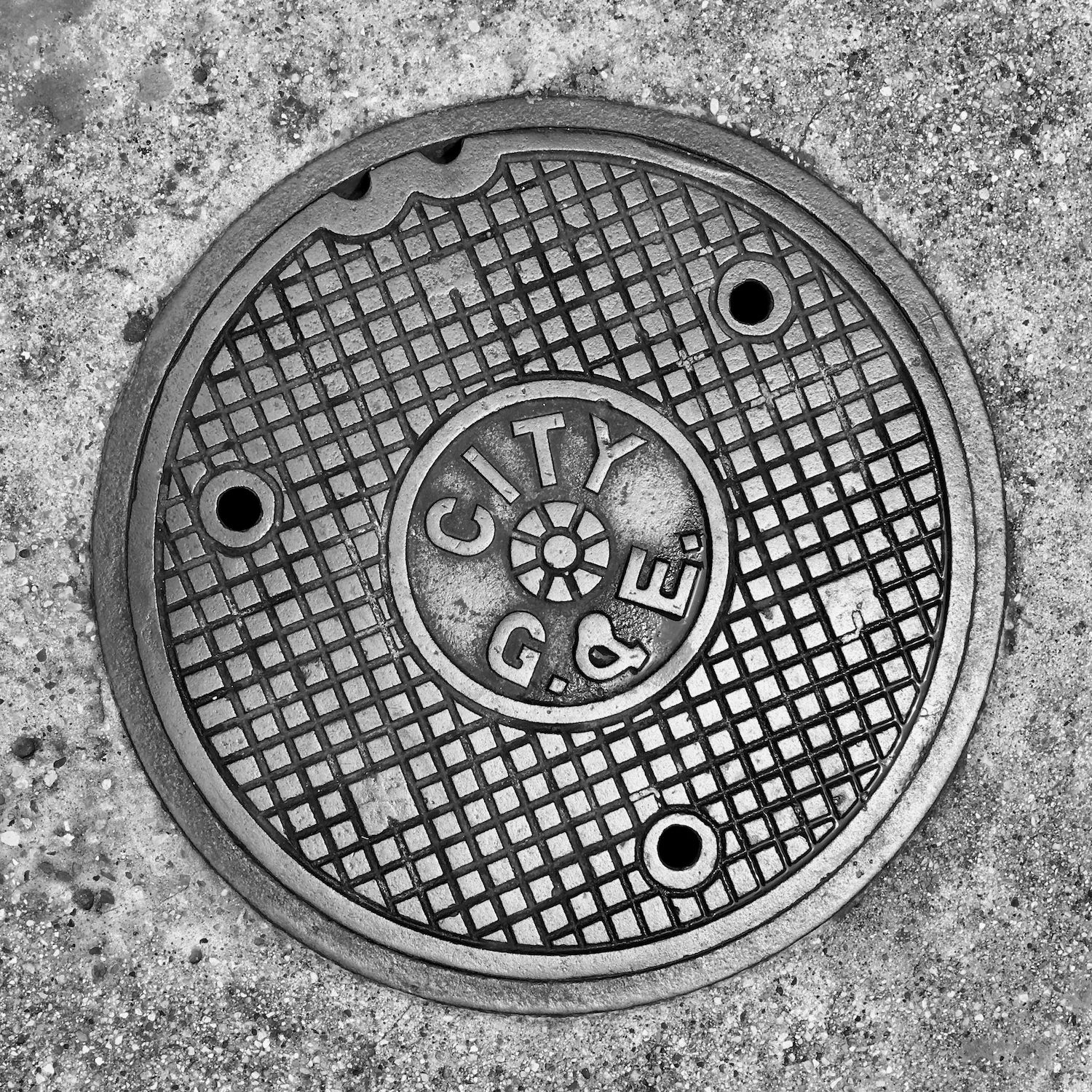black and white image of a utility cover