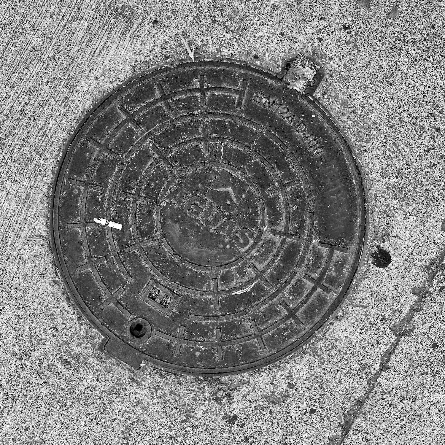 black and white image of a utility cover