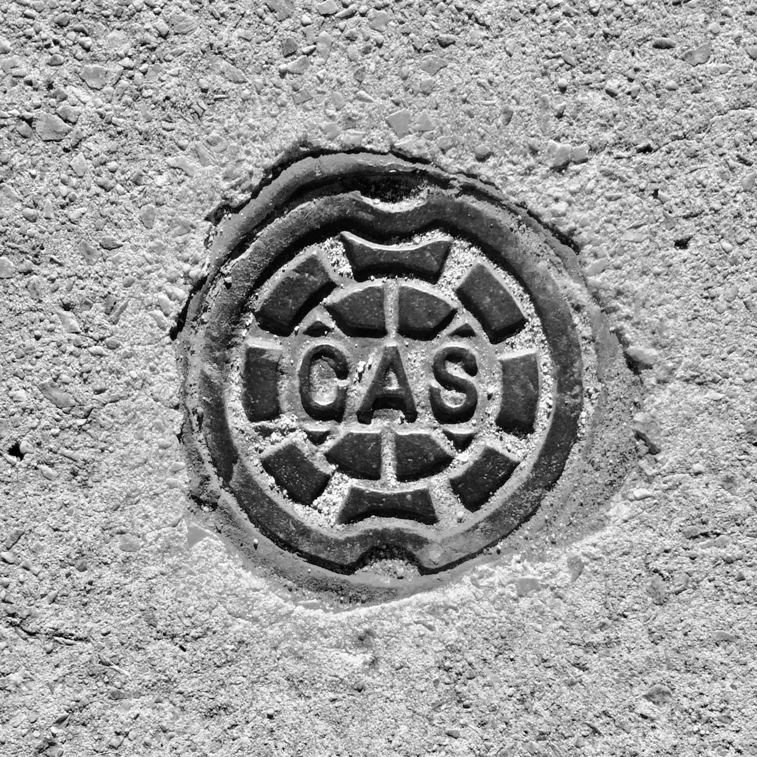 black and white image of a utility cover