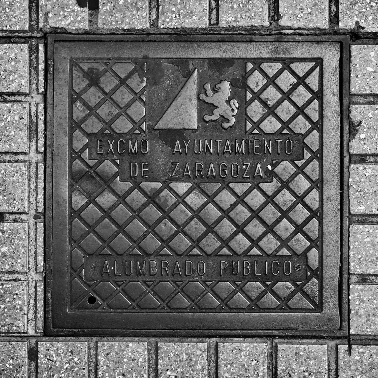 black and white image of a utility cover