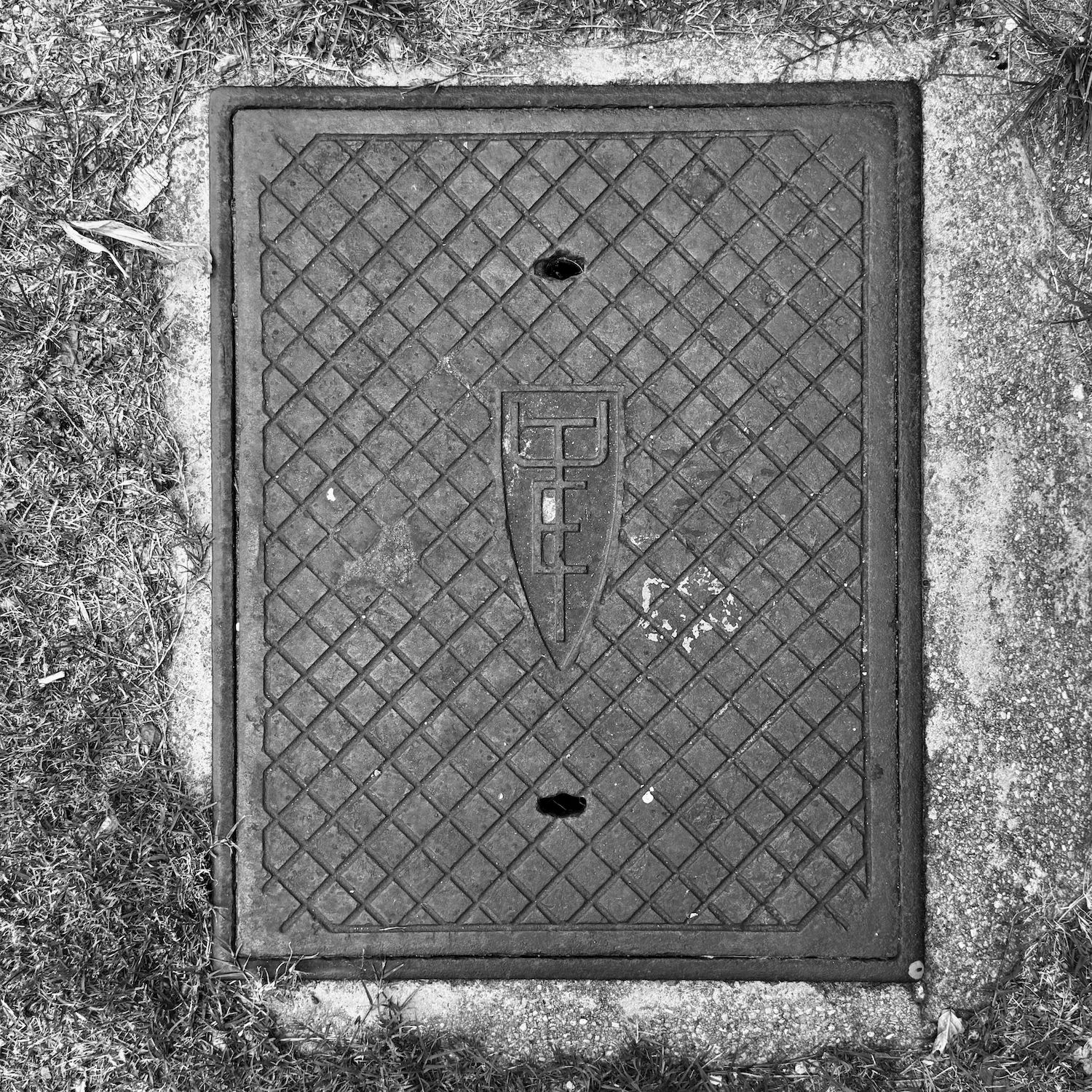 black and white image of a utility cover