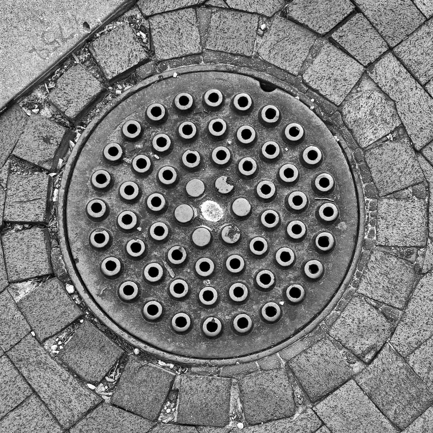 black and white image of a utility cover