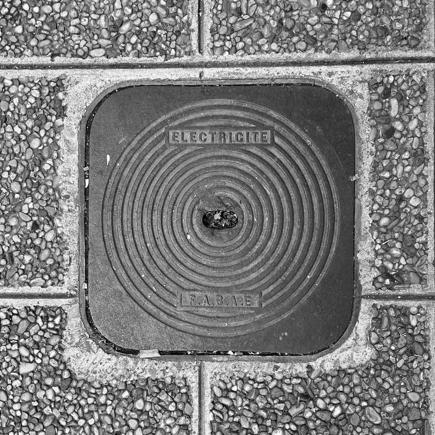 black and white image of a utility cover